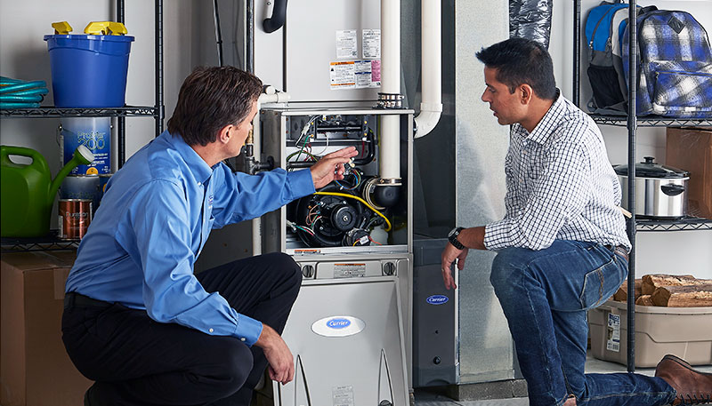HVAC technician evaluating a furnace for repair or replacement in Lehi