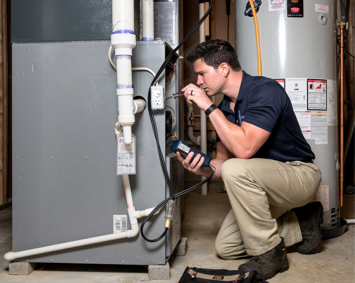 HVAC technician performing a furnace tune-up in Lehi