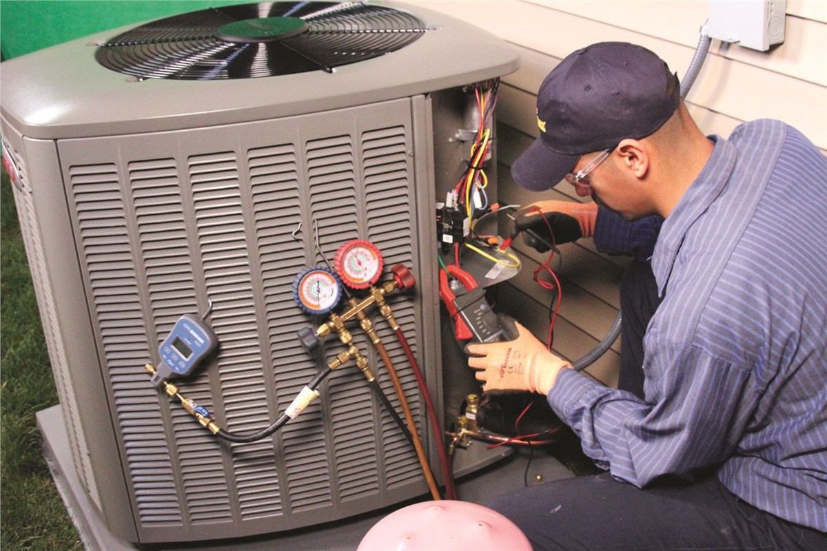 HVAC technician testing an outdoor air conditioning unit in Lehi