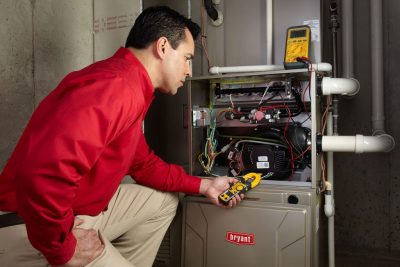 furnace repair Heating and air conditioning technician servicing an indoor furnace in Lehi, UT
